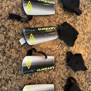 Umbro Silver and Black Shin Guards with Yellow Accents- peewee size